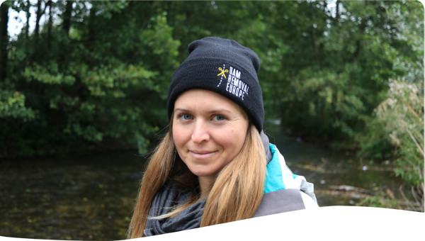 photo of a person standing at river bank