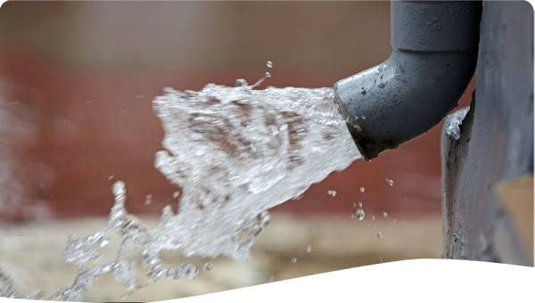 Rain Water Flowing from Plastic Gutter