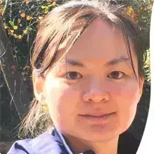 Headshot of CT who is an Asian woman with a round head and black hair